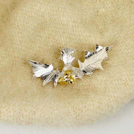 The Expanded Skies Dartmoor Holly Brooch celebrates the sculptural beauty of this native tree.

Totally handcrafted on the edge of Dartmoor and made from recycled fine and sterling silver fused with 24ct gold accents, applied using the Korean gilding process of keum boo.

Each brooch is unique. A simple and elegant addition to any outfit.