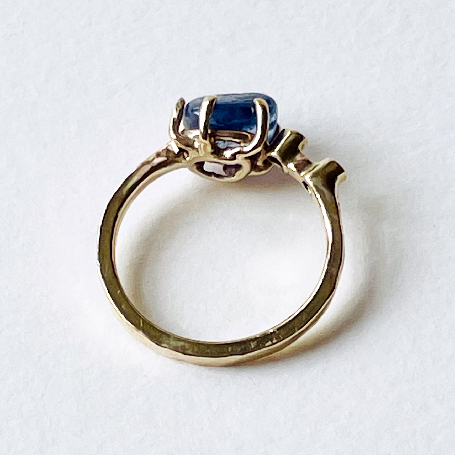 Side view - the Dartmoor Sun and Skies Sapphire Ring reflects the big Dartmoor skies, the contrasting colours and textures of the moving light over the landscape, created with ethically sourced raw and facetted sapphires and different shades of gold.