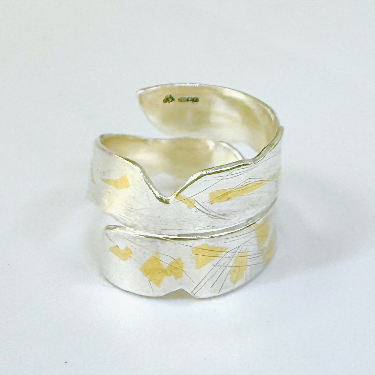 Expanded Skies River Dart Riverbed Ring with 24ct Gold Accents is inspired by the River Dart drawn with hand engraving and gold accents.