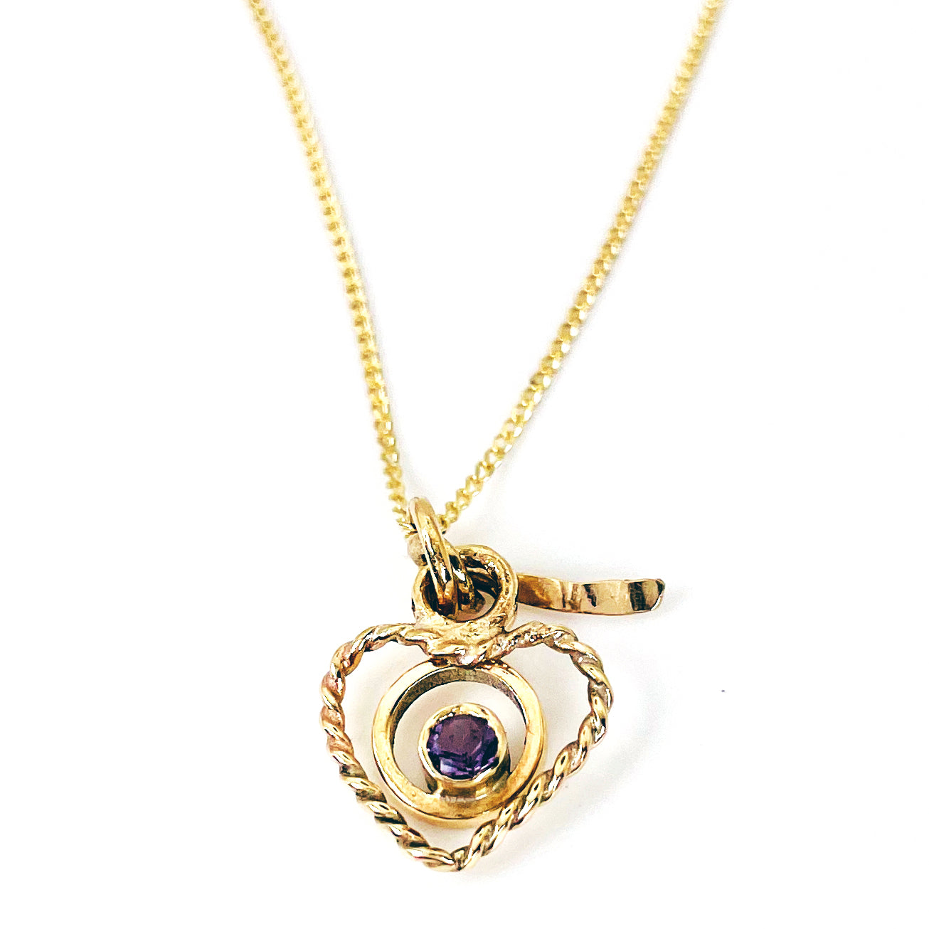 The Expanded Skies Joyful Heart Amethyst Filigree Necklace Pendant has a beautiful ethically sourced faceted amethyst set in 9ct gold bezel on a 9ct filigree gold heart. Totally handcrafted on the edge of Dartmoor and made from high quality recycled gold. Understated and beautiful, it can be worn every day or for special occasions.