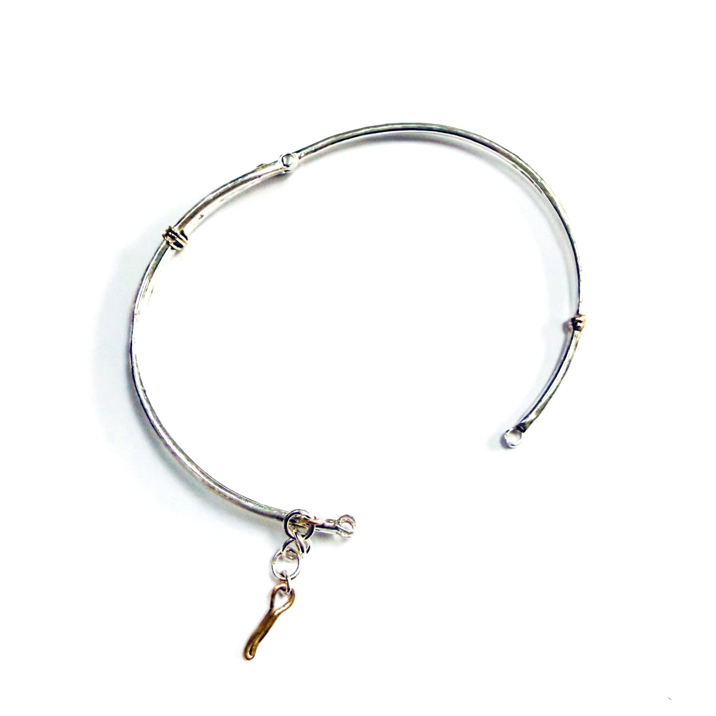 The River Dart at Hembury Hinged Bangle evokes the River Dart that flows through Hembury Woods, where the water eddies and glints as it swirls around the rocks. 
The bangle is totally handcrafted on the edge of Dartmoor and made from high quality recycled sterling silver, inlaid with recycled 9ct gold, with a textured finish that reflects the light. Shown with Expanded Skies box handcrafted in Cornwall.