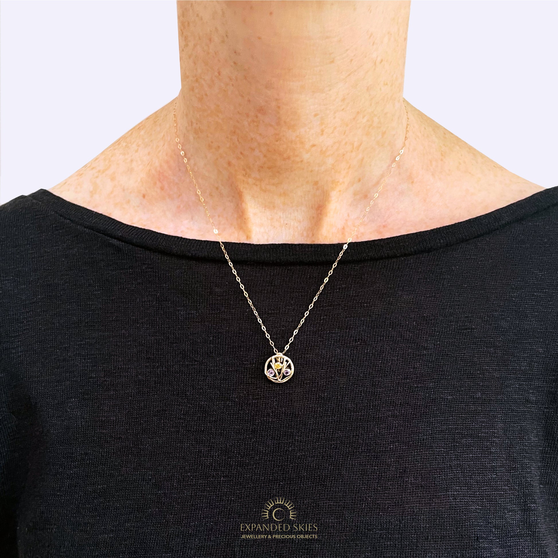 The Expanded Skies Dartmoor Heather and Gorse Pendant evokes the beautiful yellows of the gorse and purples of the heather with an ethically sourced yellow sapphire and two amethysts held in twisting branches of 9ct yellow gold. The pendant comes with a 9ct gold chain, a choice of lengths are available.
This handcrafted unique, one-off, piece makes a wonderful gift, celebrating the evocative and joyful colours of Dartmoor.