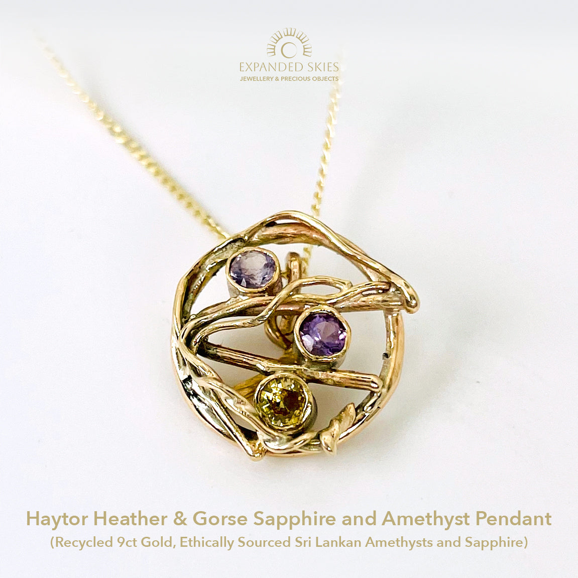 The Expanded Skies Haytor Heather and Gorse Amethyst and Sapphire Pendant evokes the beautiful yellows of the gorse and purples of the heather with an ethically sourced yellow sapphire and two amethysts held in twisting branches of 9ct yellow gold. The pendant comes with a 9ct gold chain, a choice of lengths are available.
