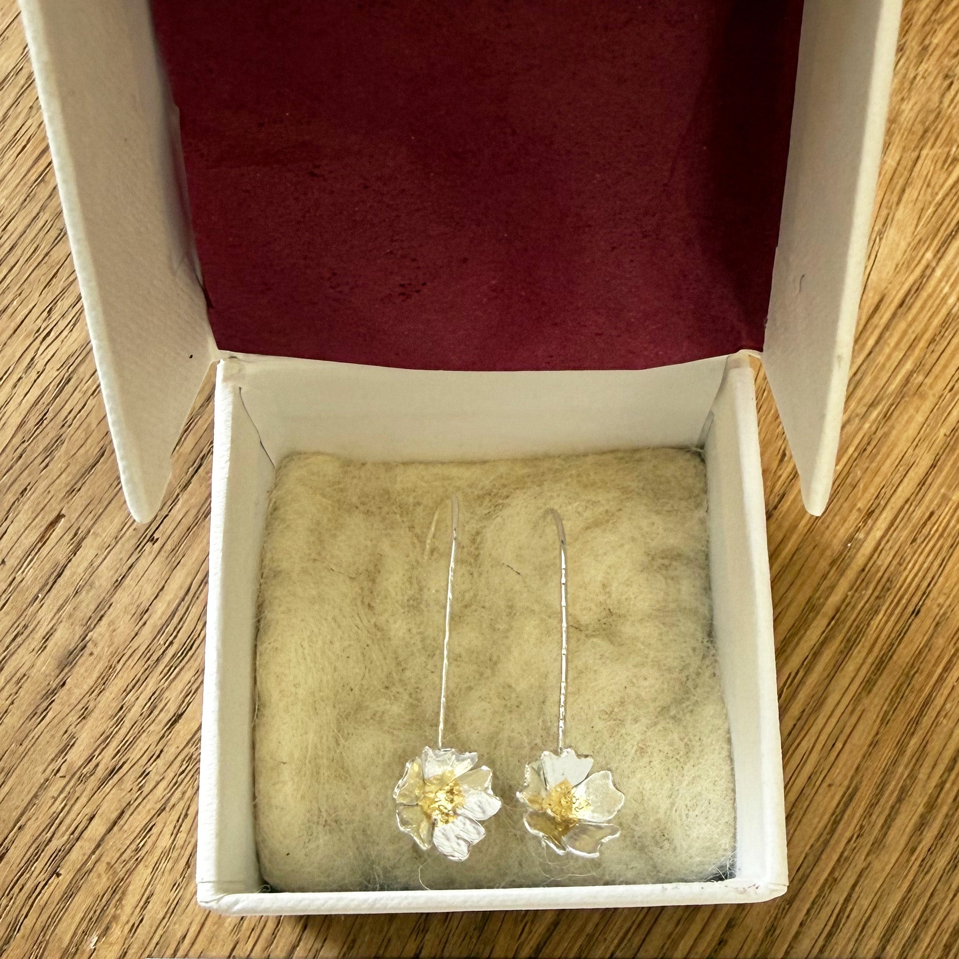 Expanded Skies packaging, a beautiful presentation box, handcrafted in Cornwall with recycled board and textured paper. The interior of the box is lined with natural felt from organically reared sheep from Fernhill Farm in Somerset and berry tissue made from recycled fibres. The box comes with a card featuring a photograph of Dartmoor taken by Emma and accompanying details of the brooch, printed on FSC certified paper. The packaging is 100% recyclable.