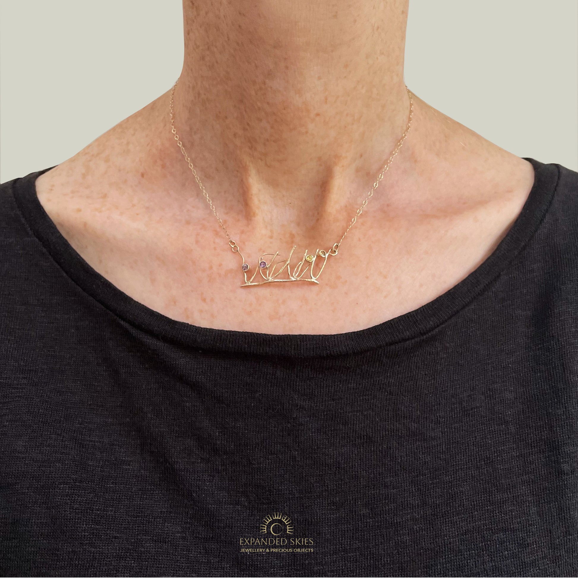 The Expanded Skies Dartmoor Heather and Gorse Necklace evokes the beautiful yellows of the gorse and purples of the heather with two ethically sourced yellow sapphires and two amethysts from Nineteen48 Ltd held in twisting branches of 9ct yellow gold. The chain can be worn at two different lengths, this picture shows shorter length.
This handcrafted unique, one-off, piece makes a wonderful gift, celebrating the evocative and joyful colours of Dartmoor.