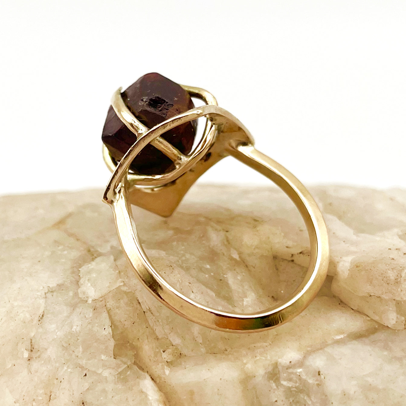 The Expanded Skies Heaven and Earth Raw Garnet Ring has a beautiful raw Norwegian garnet set in 9ct gold. The garnet is set in a distinctive completely handcrafted engraved claw setting. This is a unique piece, one-of-a-kind. Handcrafted on the edge of Dartmoor and made from high quality recycled gold, Hallmarked by the London Assay Office.