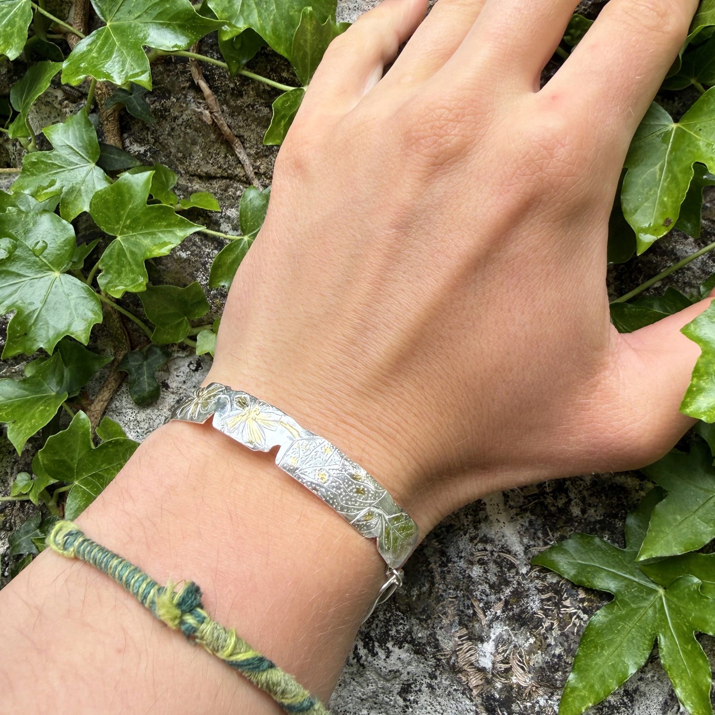 The Expanded Skies Dartmoor Purslane, Hand Engraved Bracelet, celebrates the beauty of the edible Dartmoor flower the Pink Purslane (Claytonia sibirica), created in fine and sterling silver with 24ct gold accents.