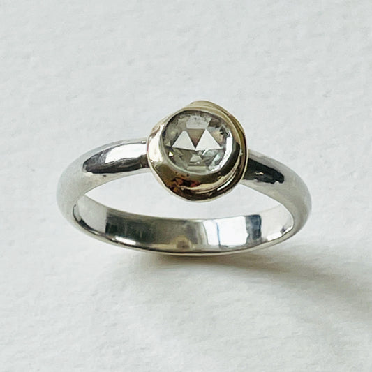 Haytor Quarry Pool White Sapphire Ring has a beautiful ethically sourced Sri Lankan faceted white 5mm sapphire, set in 9ct gold, on sterling silver band. Completely handcrafted from high quality recycled sterling silver and recycled gold. Understated and beautiful, it can be worn every day and for special occasions.