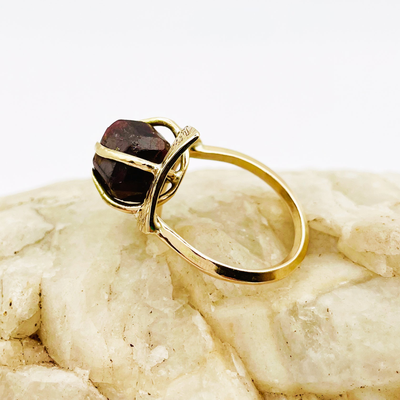 The Expanded Skies Heaven and Earth Raw Garnet Ring has a beautiful raw Norwegian garnet set in 9ct gold. The garnet is set in a distinctive completely handcrafted engraved claw setting. This is a unique piece, one-of-a-kind. Handcrafted on the edge of Dartmoor and made from high quality recycled gold, Hallmarked by the London Assay Office.