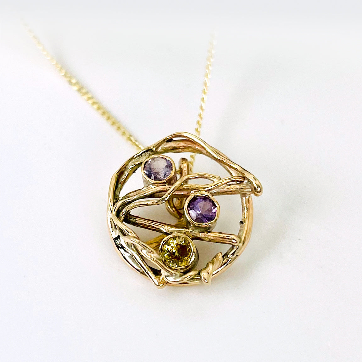 The Expanded Skies Haytor Heather and Gorse Amethyst and Sapphire Pendant evokes the beautiful yellows of the gorse and purples of the heather with an ethically sourced yellow sapphire and two amethysts held in twisting branches of 9ct yellow gold. The pendant comes with a 9ct gold chain, a choice of lengths are available.