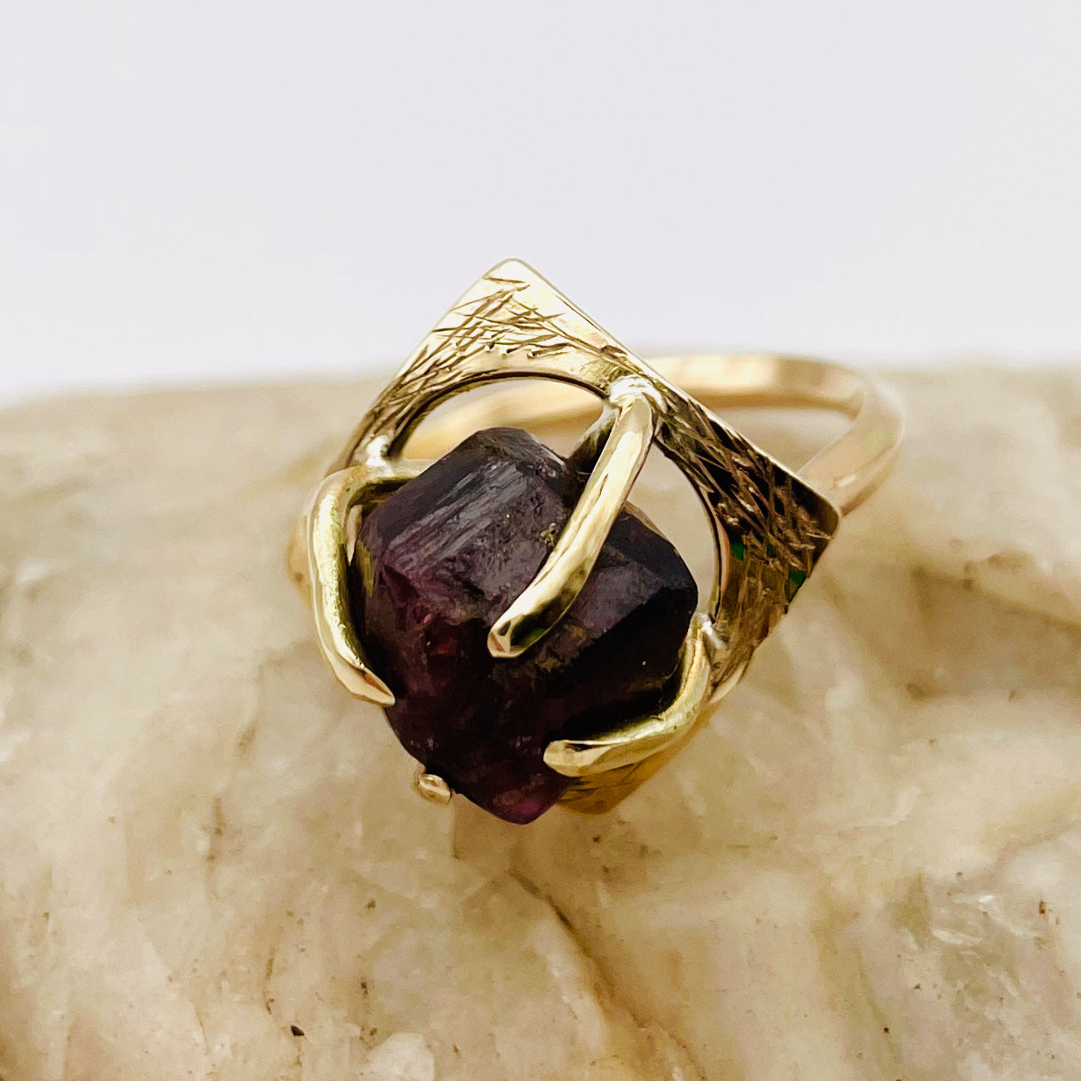 The Expanded Skies Heaven and Earth Raw Garnet Ring has a beautiful raw Norwegian garnet set in 9ct gold. The garnet is set in a distinctive completely handcrafted engraved claw setting. This is a unique piece, one-of-a-kind. Handcrafted on the edge of Dartmoor and made from high quality recycled gold, Hallmarked by the London Assay Office.