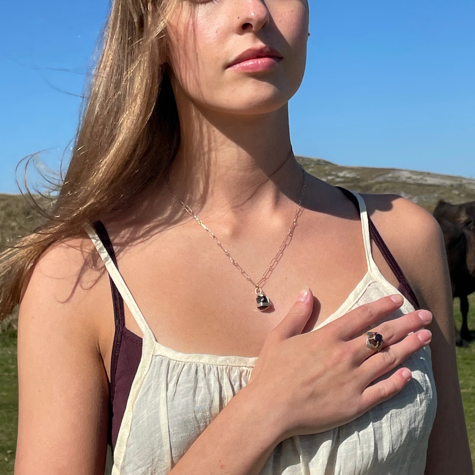 The Expanded Skies Heaven and Earth Raw Garnet Ring has a beautiful raw Norwegian garnet set in 9ct gold. The garnet is set in a distinctive completely handcrafted engraved claw setting. This is a unique piece, one-of-a-kind. Handcrafted on the edge of Dartmoor and made from high quality recycled gold, Hallmarked by the London Assay Office.