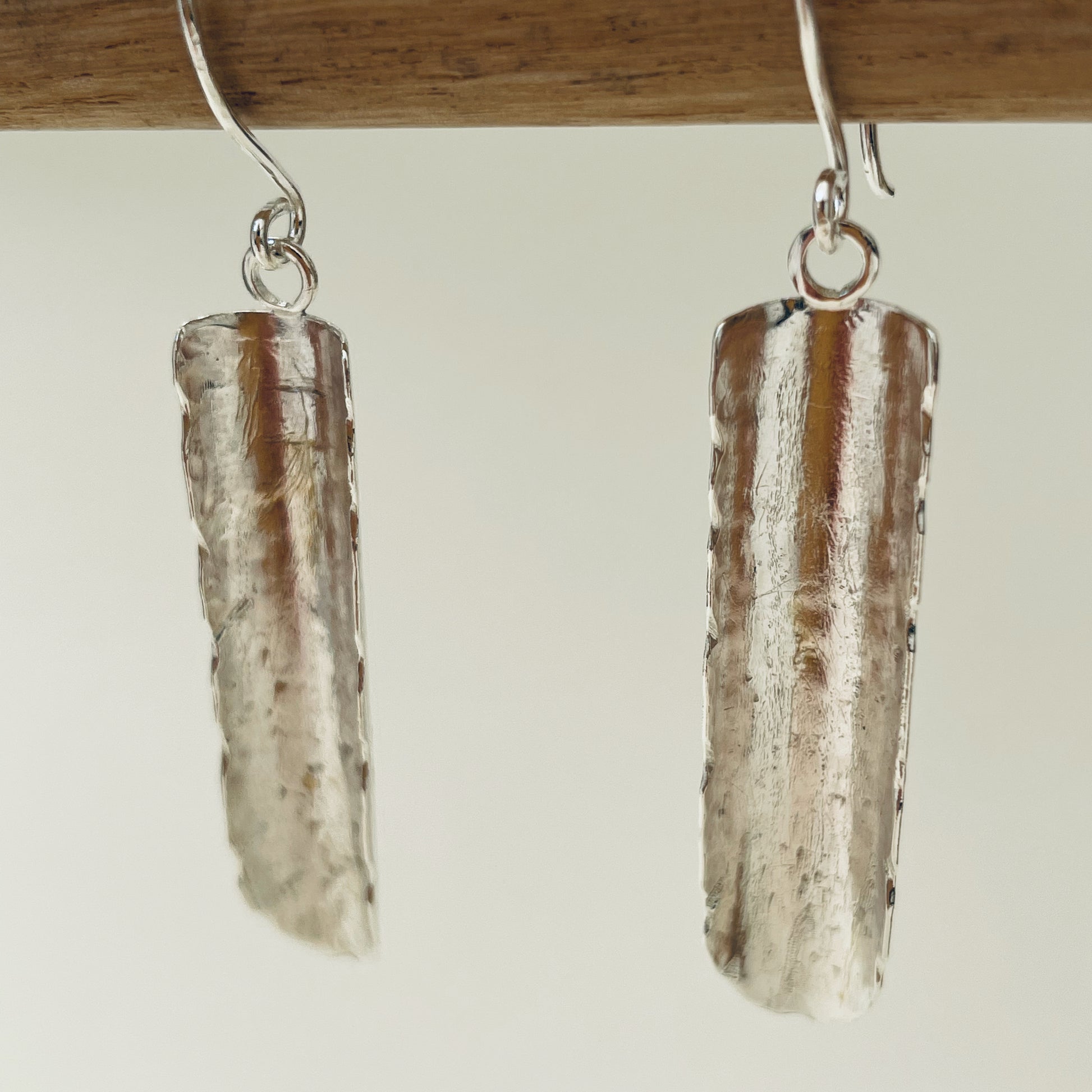 Inspired by the enchanting Holne woods waterfall, the Expanded Skies, Dartmoor Waterfall Earrings are handcrafted from solid recycled sterling silver with recycled sterling silver handcrafted ear wires. Simple and elegant, with an engraved texture on all sides. They can be worn everyday.