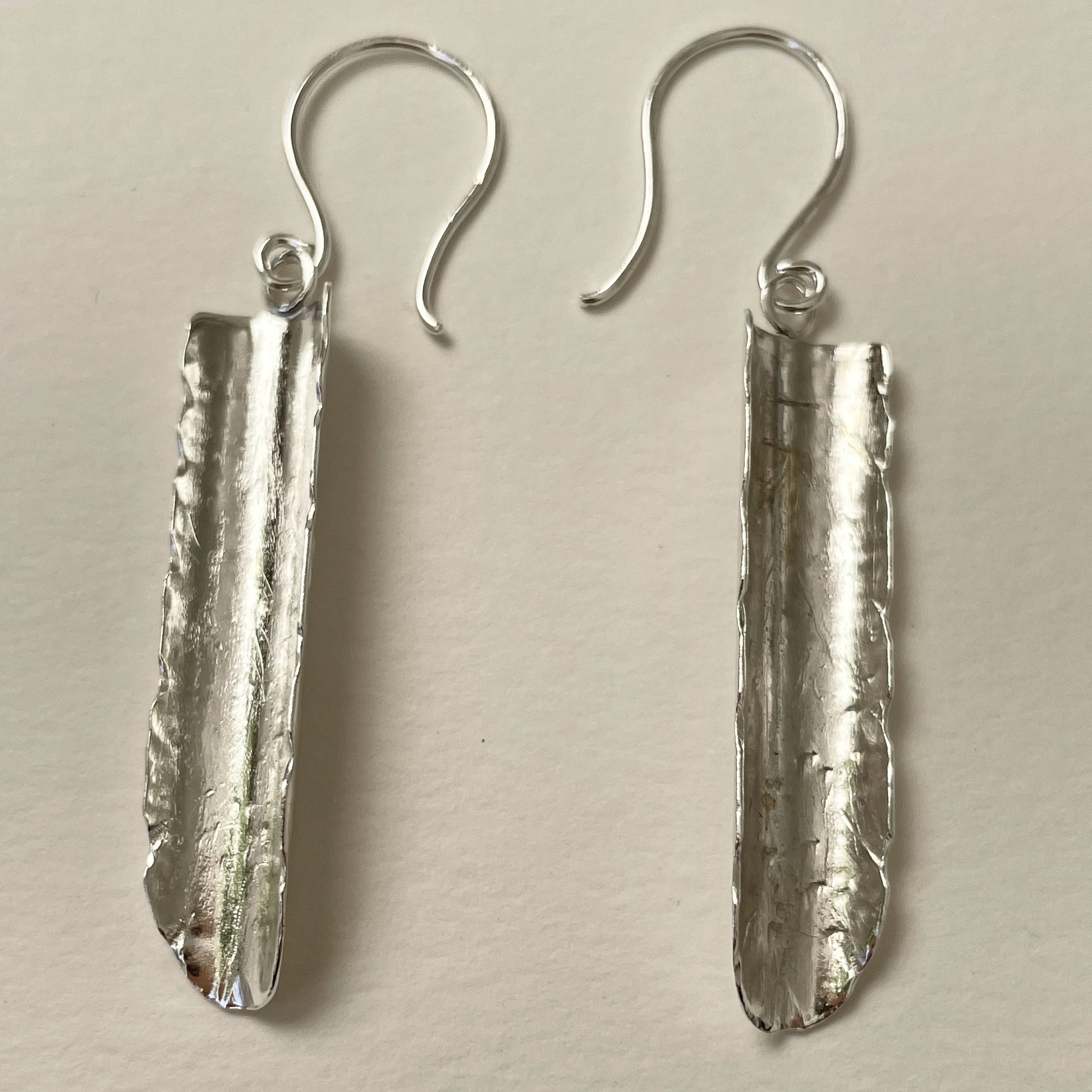 Inspired by the enchanting Holne woods waterfall, the Expanded Skies, Dartmoor Waterfall Earrings are handcrafted from solid recycled sterling silver with recycled sterling silver handcrafted ear wires. Simple and elegant, with an engraved texture on all sides. They can be worn everyday.