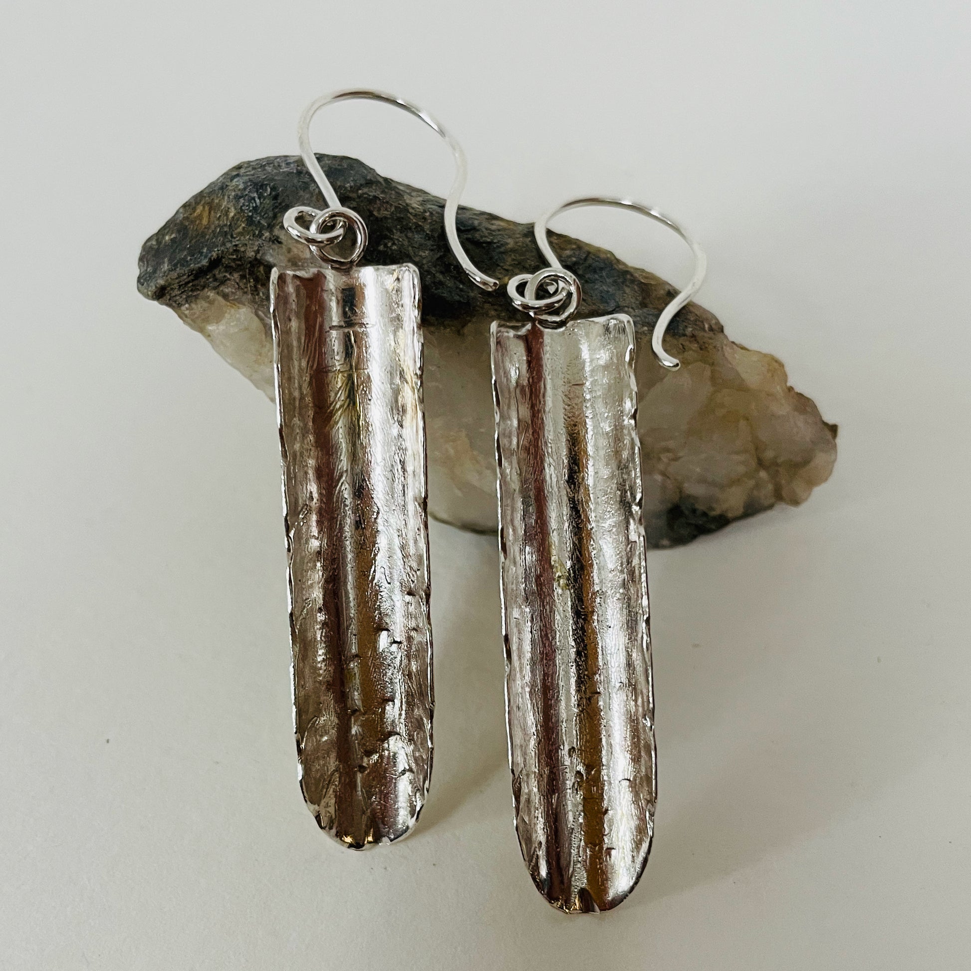 Inspired by the enchanting Holne woods waterfall, the Expanded Skies, Dartmoor Waterfall Earrings are handcrafted from solid recycled sterling silver with recycled sterling silver handcrafted ear wires. Simple and elegant, with an engraved texture on all sides. They can be worn everyday.