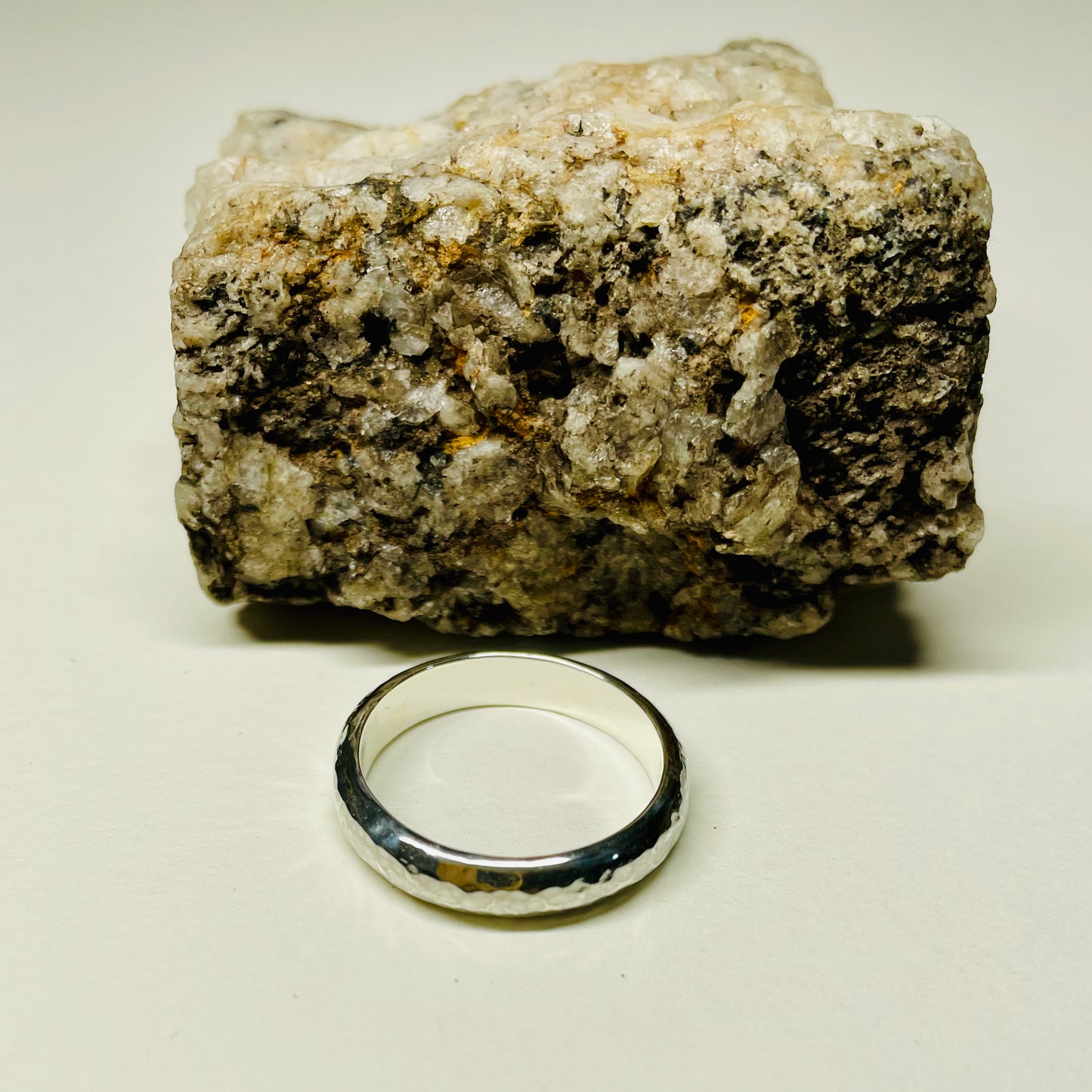 The Dartmoor Wide Hammered Ring is inspired by the sculptural beauty of the granite moorland. The hammered polished finish reflects the light beautifully. The band is handcrafted from sold sterling recycled silver. Suits everyone.