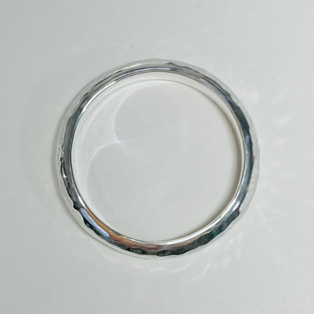 The Dartmoor Wide Hammered Ring is inspired by the sculptural beauty of the granite moorland. The hammered polished finish reflects the light beautifully. The band is handcrafted from sold sterling recycled silver. Suits everyone.