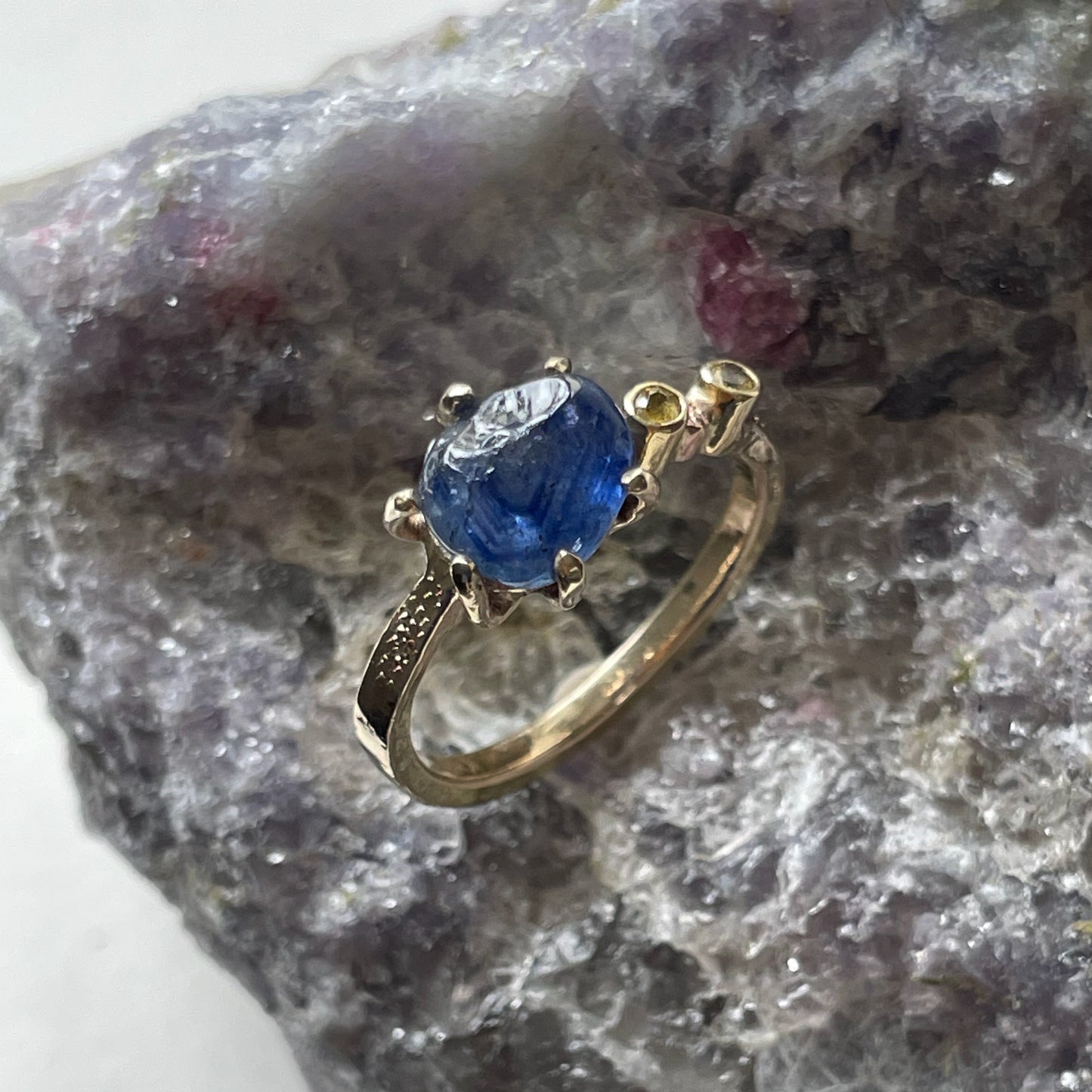 The Dartmoor Sun and Skies Sapphire Ring reflects the big Dartmoor skies, the contrasting colours and textures of the moving light over the landscape, created with ethically sourced raw and facetted sapphires and different shades of gold.