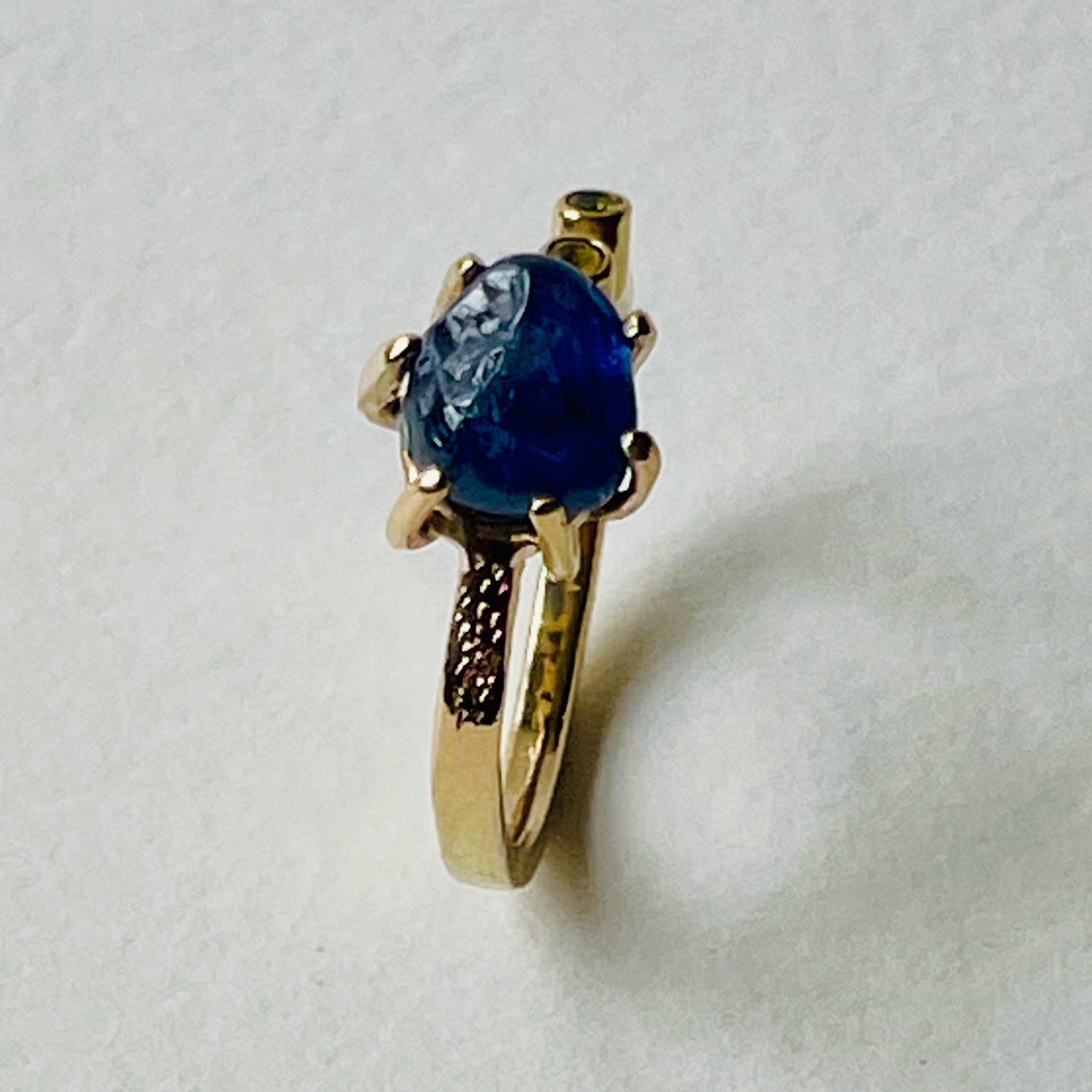 The Dartmoor Sun and Skies Sapphire Ring reflects the big Dartmoor skies, the contrasting colours and textures of the moving light over the landscape, created with ethically sourced raw and facetted sapphires and different shades of gold.