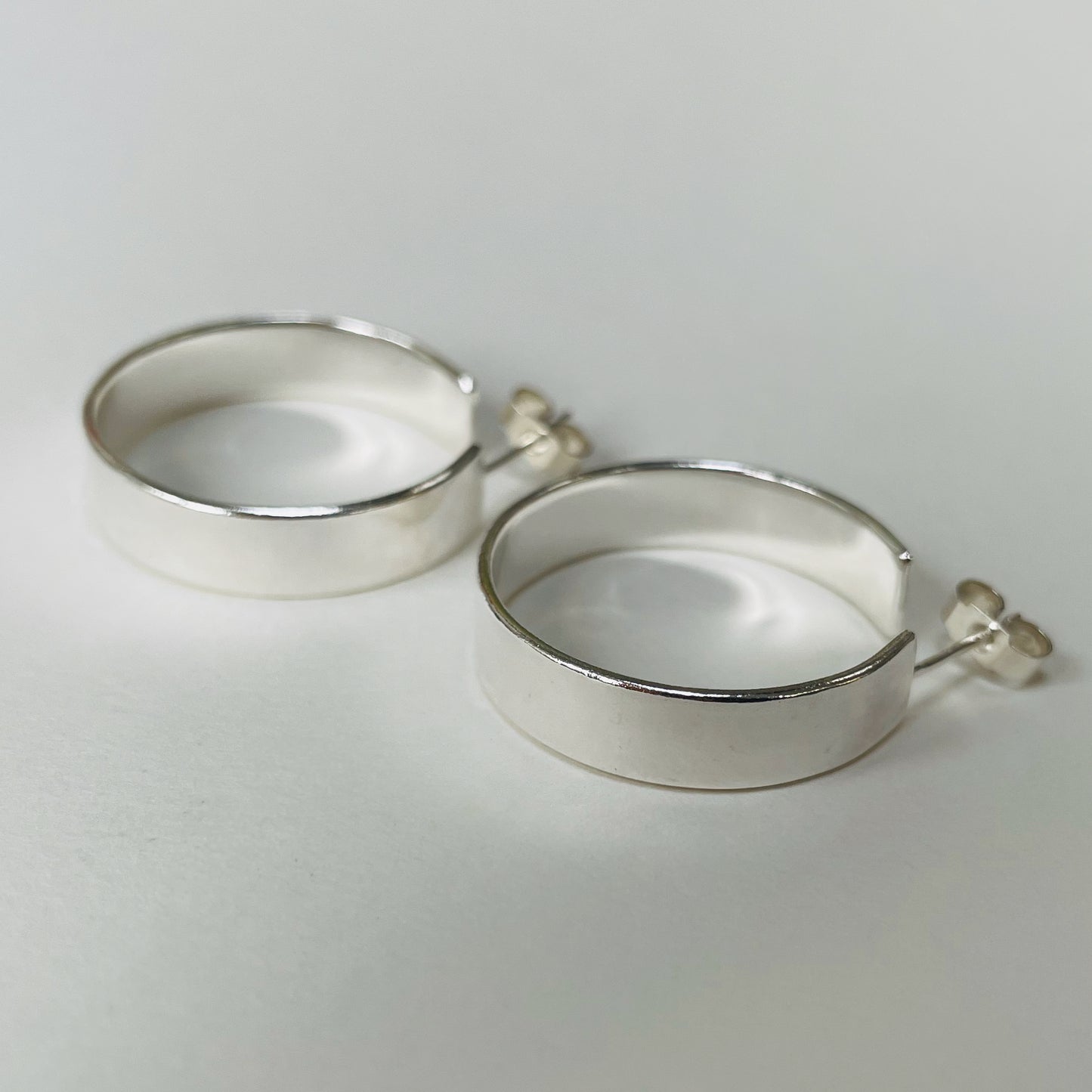 The Expanded Skies, Dartmoor Wide Hoop Earrings are handcrafted from solid recycled sterling silver with a recycled sterling silver pin and scroll back. Simple and elegant, they can be worn everyday to accompany any occasion.