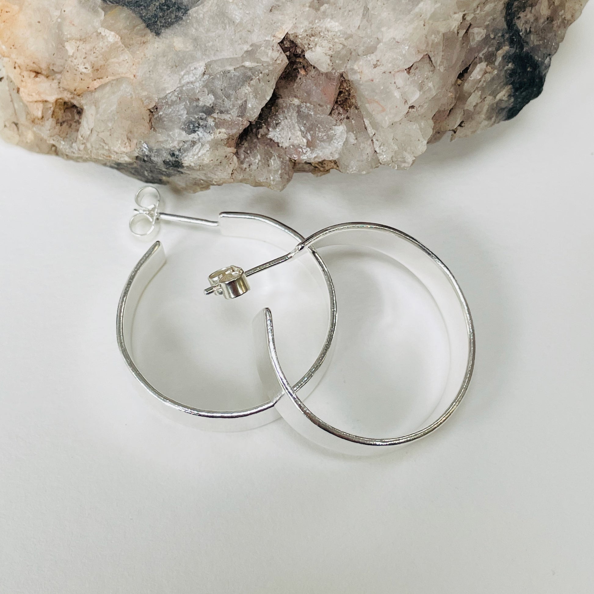 The Expanded Skies, Dartmoor Wide Hoop Earrings are handcrafted from solid recycled sterling silver with a recycled sterling silver pin and scroll back. Simple and elegant, they can be worn everyday to accompany any occasion.