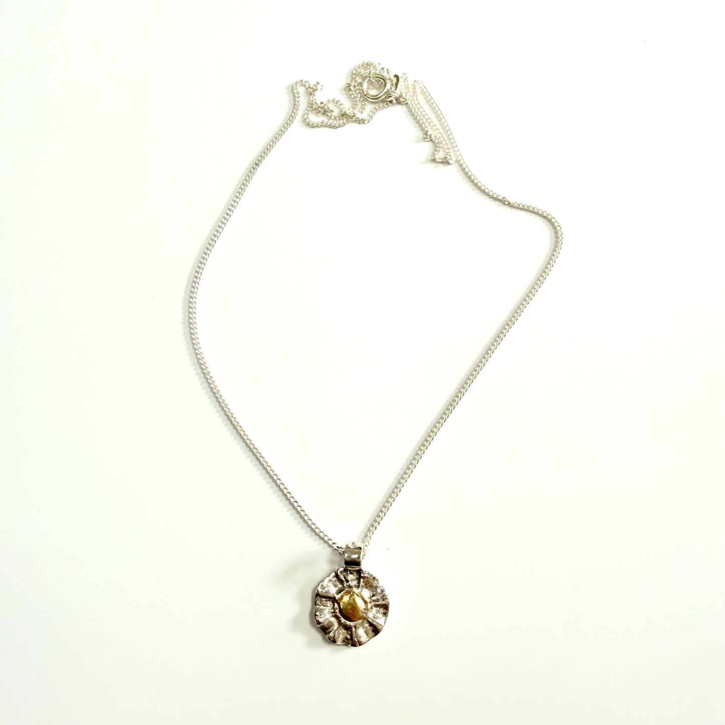 The Expanded Skies Radiant Sun Pendant&nbsp;is joyful! Hand sculpted and cast in recycled solid fine silver (999) with a textured surface that has a twinkly beauty all of its own. Each sun is unique.