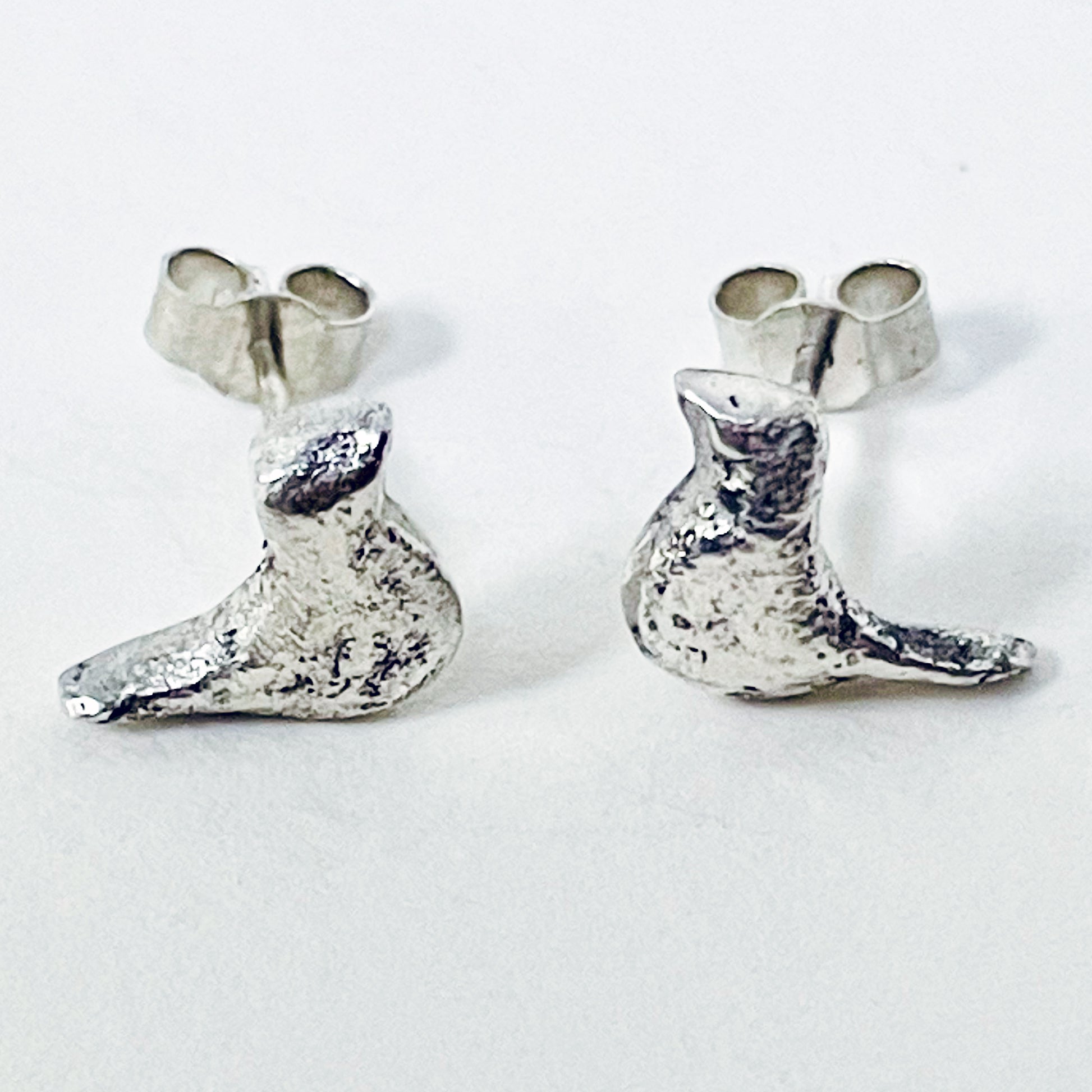 The Dartmoor Moorland Bird Studs are handcrafted in recycled fine silver with recycled sterling silver ear pins and scrolls, each bird is unique. Simple and elegant with a hammered finish, they can be worn everyday for any occasion.