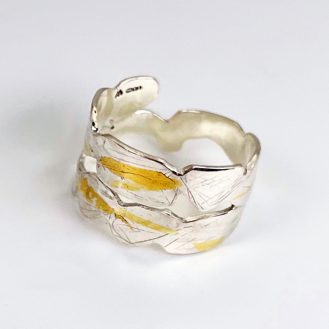 Expanded Skies Bone Tor Ring with 24ct Gold Accents is inspired by the contours and forms of Dartmoor’s Bone Tor, near Widdecombe on the Moor, at sunset. Fine silver with 24ct gold accents.