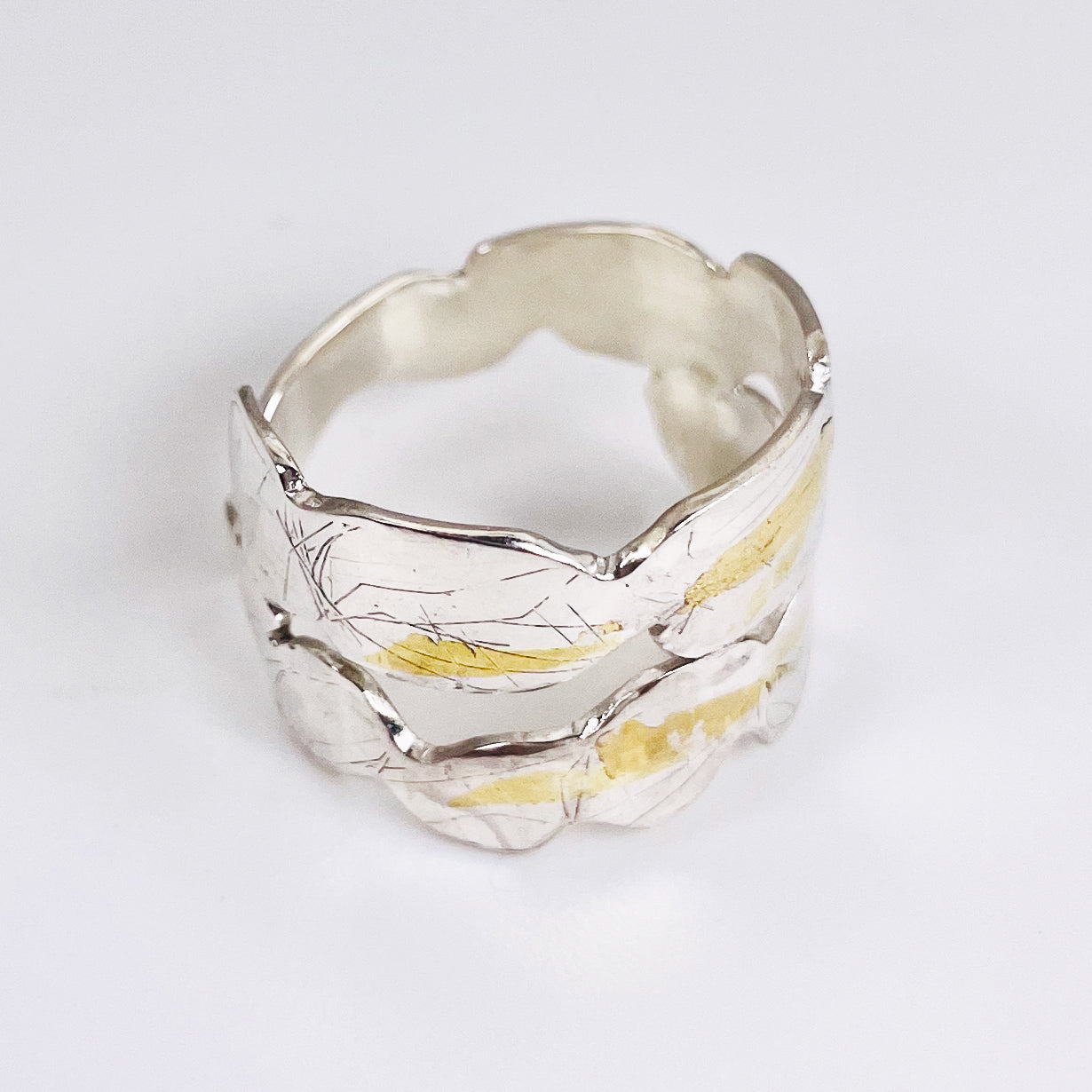 Expanded Skies Bone Tor Ring with 24ct Gold Accents is inspired by the contours and forms of Dartmoor’s Bone Tor, near Widdecombe on the Moor, at sunset. Fine silver with 24ct gold accents.
