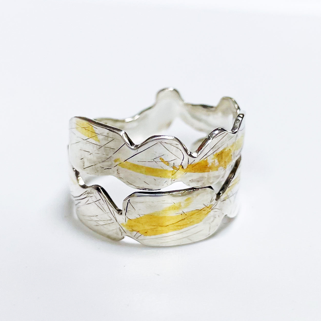 Expanded Skies Bone Tor Ring with 24ct Gold Accents is inspired by the contours and forms of Dartmoor’s Bone Tor, near Widdecombe on the Moor, at sunset. Fine silver with 24ct gold accents.