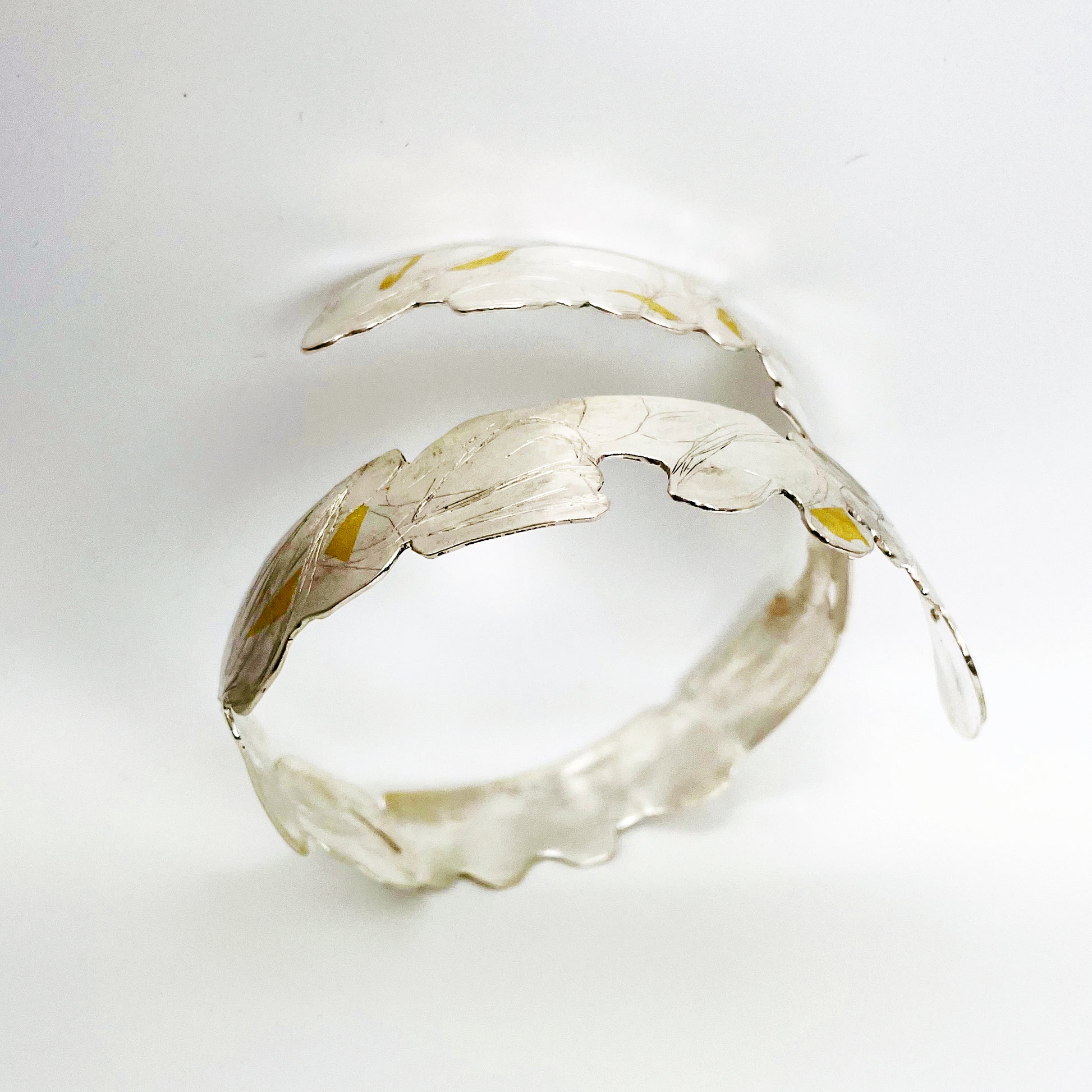 Expanded Skies Bone Tor Bangle with 24ct Gold Accents is inspired by the contours and forms of Dartmoor’s Bone Tor, near Widdecombe on the Moor, at sunset. Fine silver with 24ct gold accents.