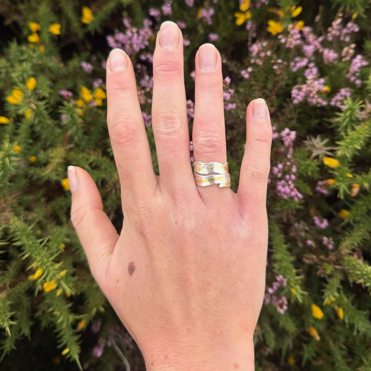 Expanded Skies River Dart Riverbed Ring with 24ct Gold Accents is inspired by the River Dart drawn with hand engraving and gold accents.