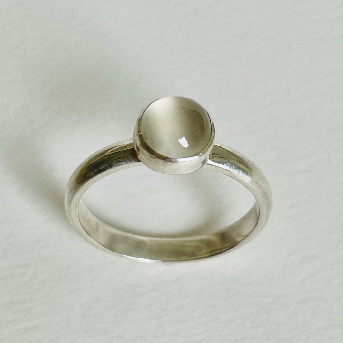 The Full Moon Moonstone Ring has a tranquil beauty of the light of the full moon reflected on a still pool. Totally handcrafted, it features an ethically mined moonstone from Sri Lanka set in quality 100% recycled sterling silver. 