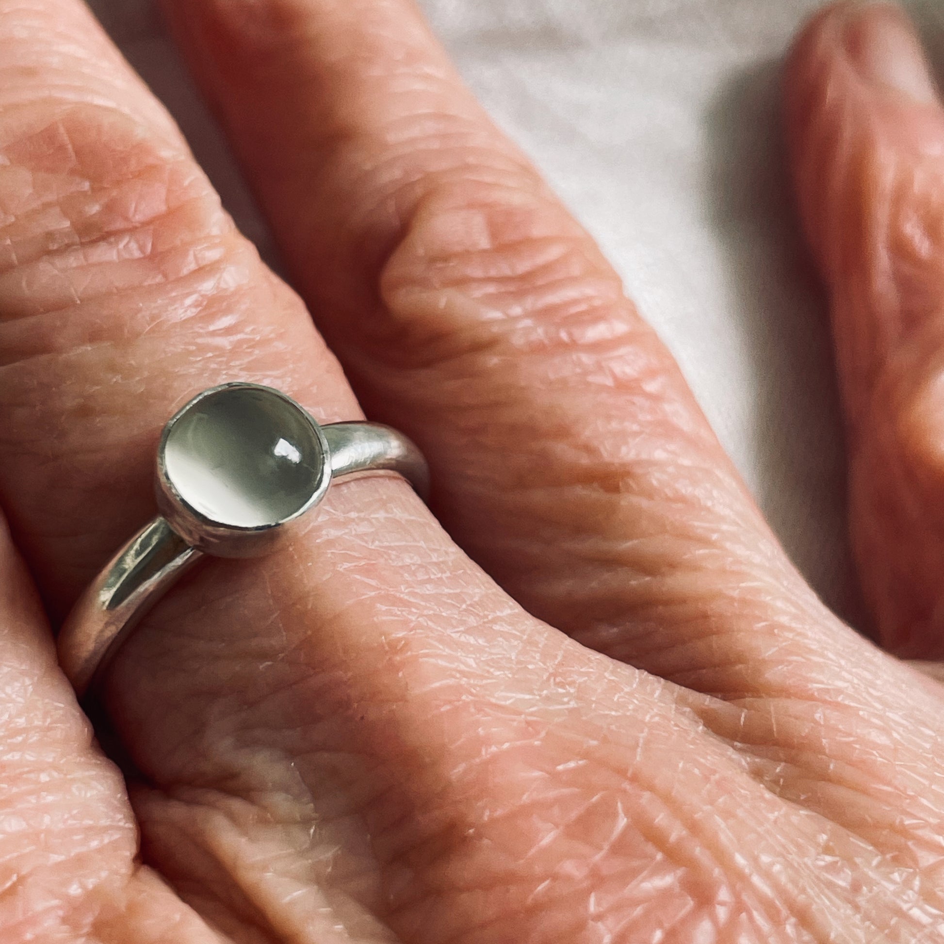 The Full Moon Moonstone Ring has a tranquil beauty of the light of the full moon reflected on a still pool. Totally handcrafted, it features an ethically mined moonstone from Sri Lanka set in quality 100% recycled sterling silver. 