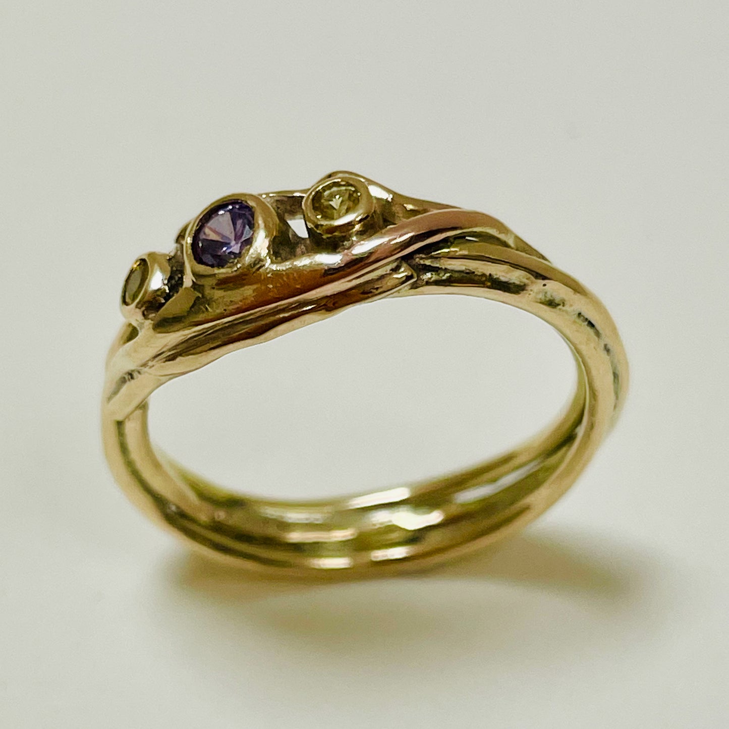 The Haytor Heather and Gorse Ring evokes the beautiful yellows of the gorse and purples of the heather with ethically sourced yellow sapphires and a purple spinel held in three twisting &nbsp;branches of 9ct yellow with accents of 9ct rose gold . This totally handcrafted piece makes a wonderful gift, engagement ring or perfect encapsulation of joy.