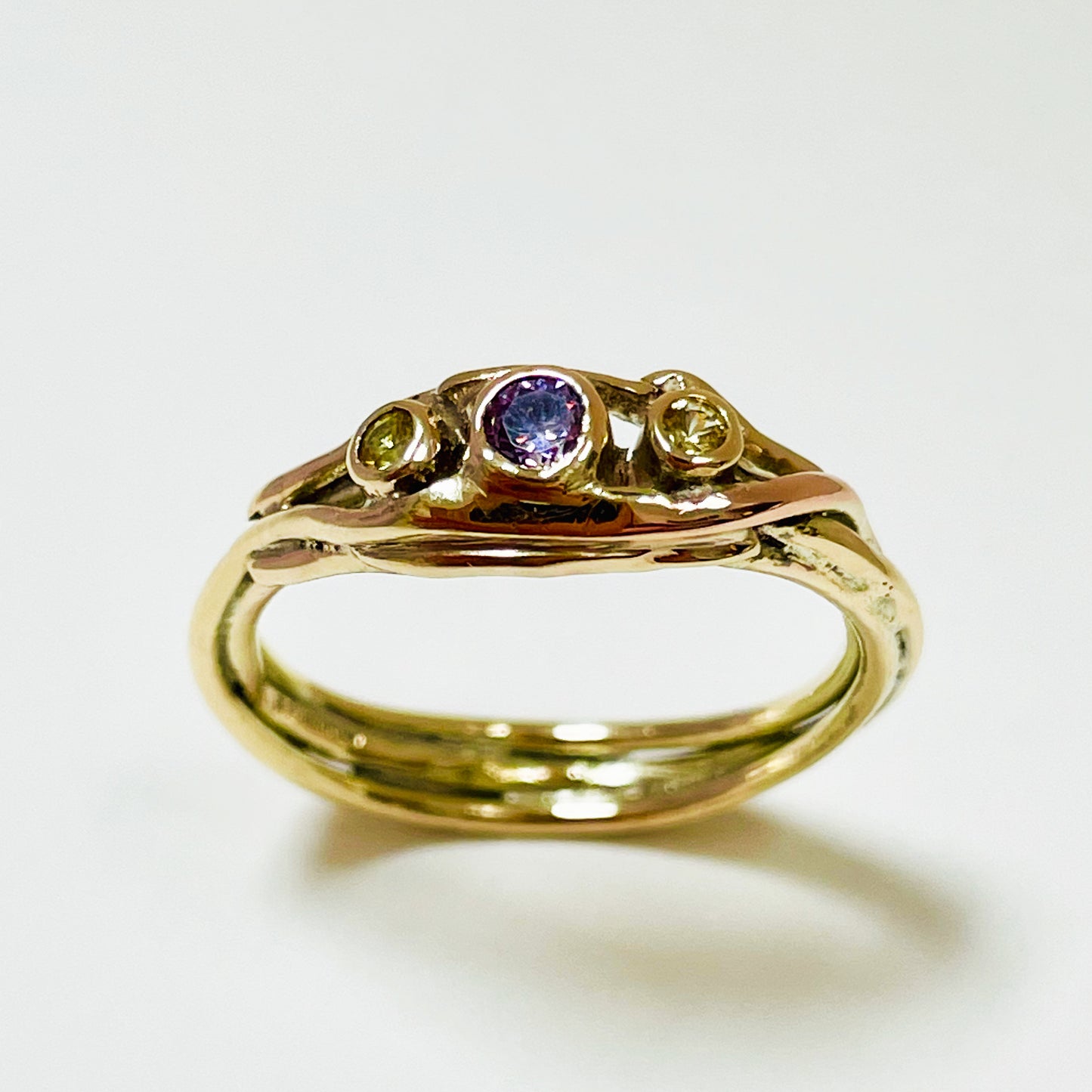 The Haytor Heather and Gorse Ring evokes the beautiful yellows of the gorse and purples of the heather with ethically sourced yellow sapphires and a purple spinel held in three twisting &nbsp;branches of 9ct yellow with accents of 9ct rose gold . This totally handcrafted piece makes a wonderful gift, engagement ring or perfect encapsulation of joy.