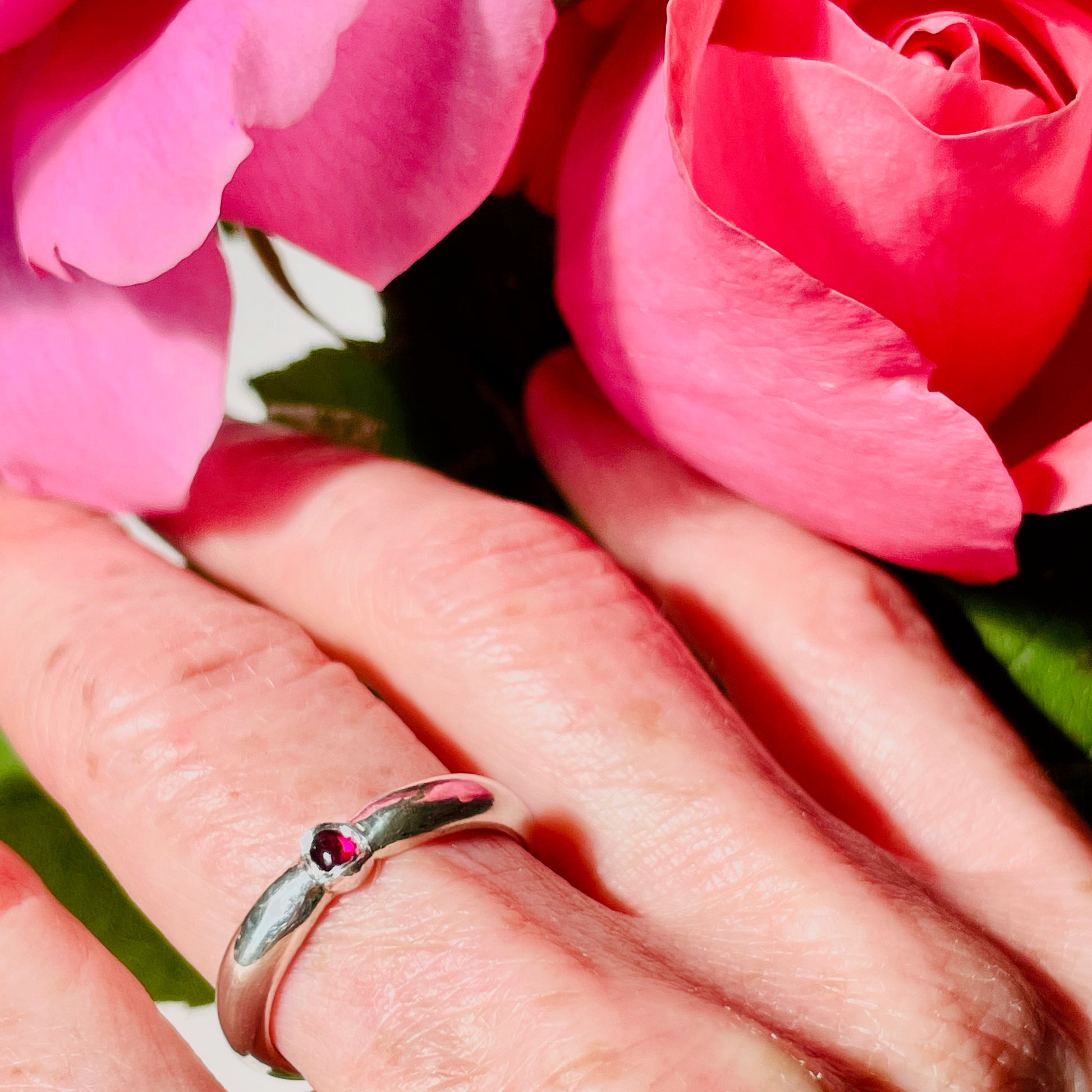 The Ruby-Joy Ring is has a hint of the 1950's exuberance of pinched waists and wide skirts, with a tapering silver band that clasps the oval lustrous pink-red ethically sourced Greenland ruby. With a timeless elegance that can be worn everyday or for special occasions.  Dimensions:  2mm D-shaped recycled sterling silver band 4mm x 3mm approx Ethically Mined Greenland Ruby