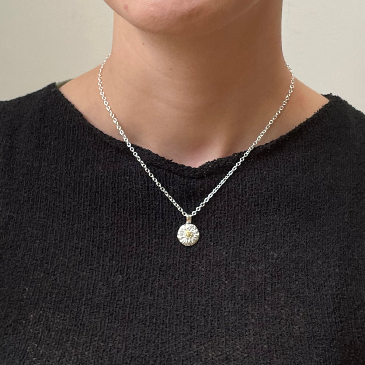 The Expanded Skies Dartmoor Daisy Sapphire Necklace in sterling silver and 9ct gold is inspired by the Erigeron Karvinskianus, commonly known as the 'Dartmoor Daisy'. It comes with 16” Italian spiga rolled chain, made from recycled sterling silver. The daisy pendant measures 12mm, the bail measures 6mm, total length 18mm with a depth of 2mm (approx). Each piece is individually saw pierced, hand engraved and
unique. 