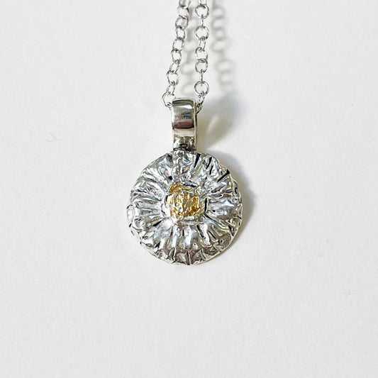 The Expanded Skies Michaelmas Daisy Pendant is totally handcrafted in 100% recycled fine silver (999) with 22ct gold.  It has a textured surface that has a twinkly beauty all of its own. 22ct heavy gold foil is applied using keum boo, a traditional Korean gilding technique, that uses heat and pressure, which makes each piece unique. It can be worn every day or for more formal occasions.