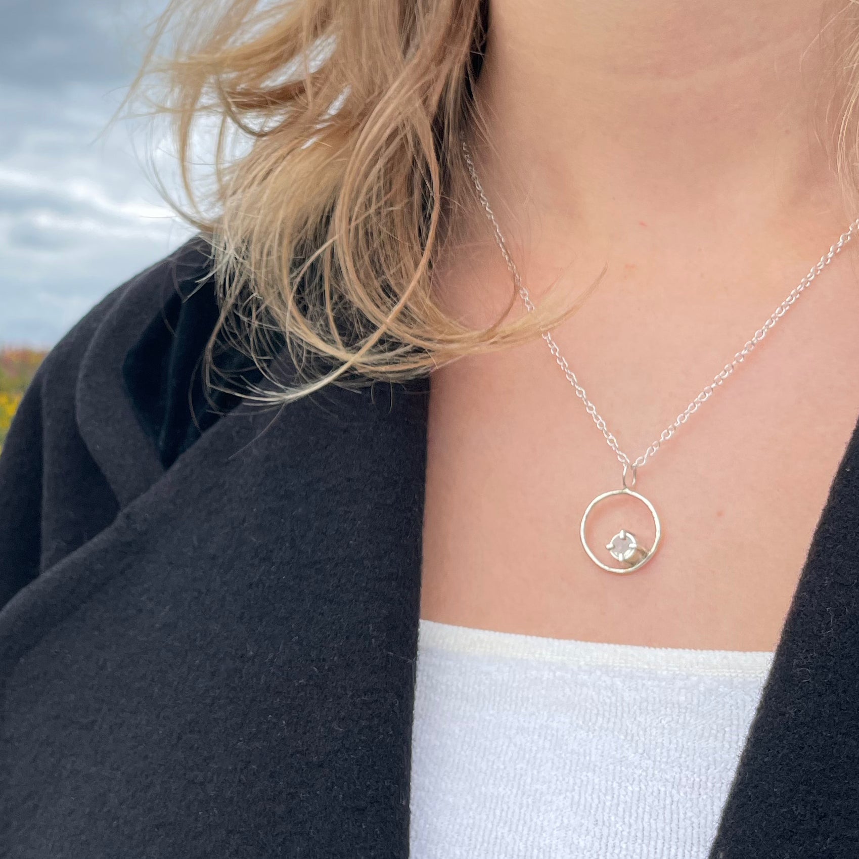 The Moon Light White Sapphire pendant sparkles as its facets reflects the light. The beautiful 5mm rose cut ethically mined Sri Lankan white sapphire has a handcrafted four claw setting on a hammered silver sterling silver band. Understated and beautiful, it can be worn everyday or for special occasions. The pendant comes with a 1.7mm recycled sterling silver trace chain