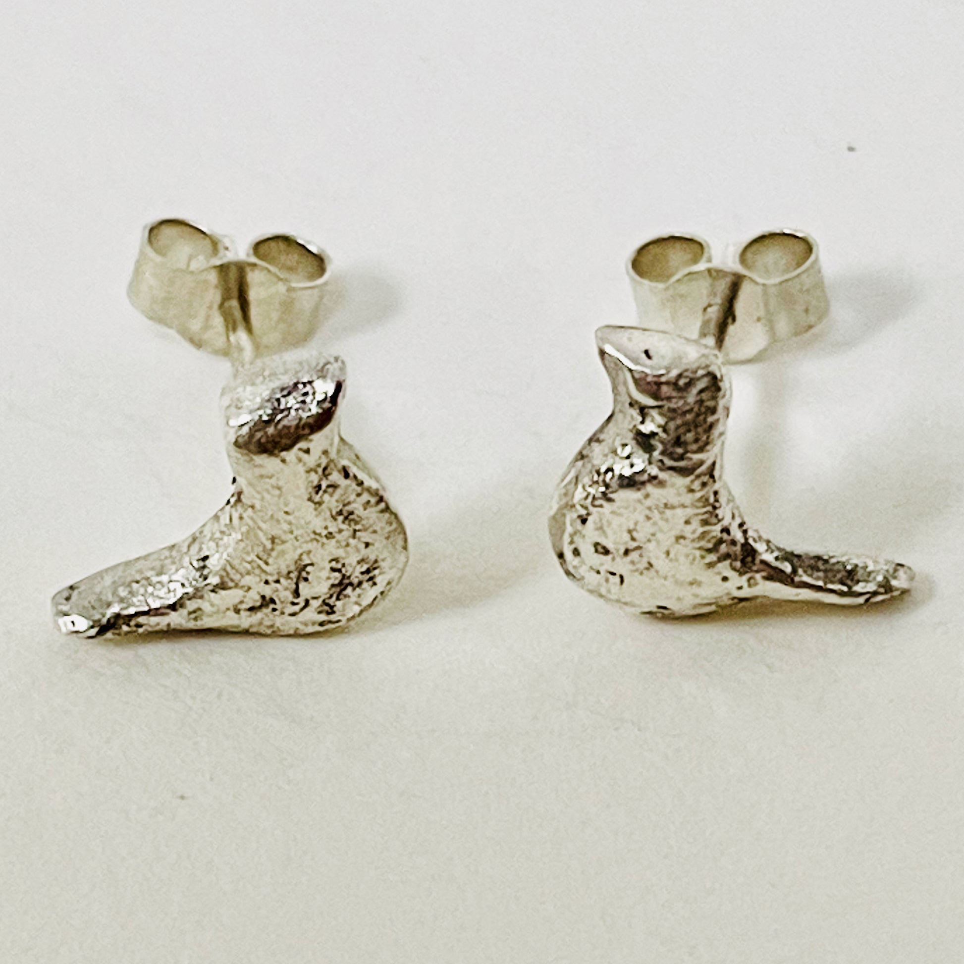 The Dartmoor Moorland Bird Studs are handcrafted in recycled fine silver with recycled sterling silver ear pins and scrolls, each bird is unique. Simple and elegant with a hammered finish, they can be worn everyday for any occasion.