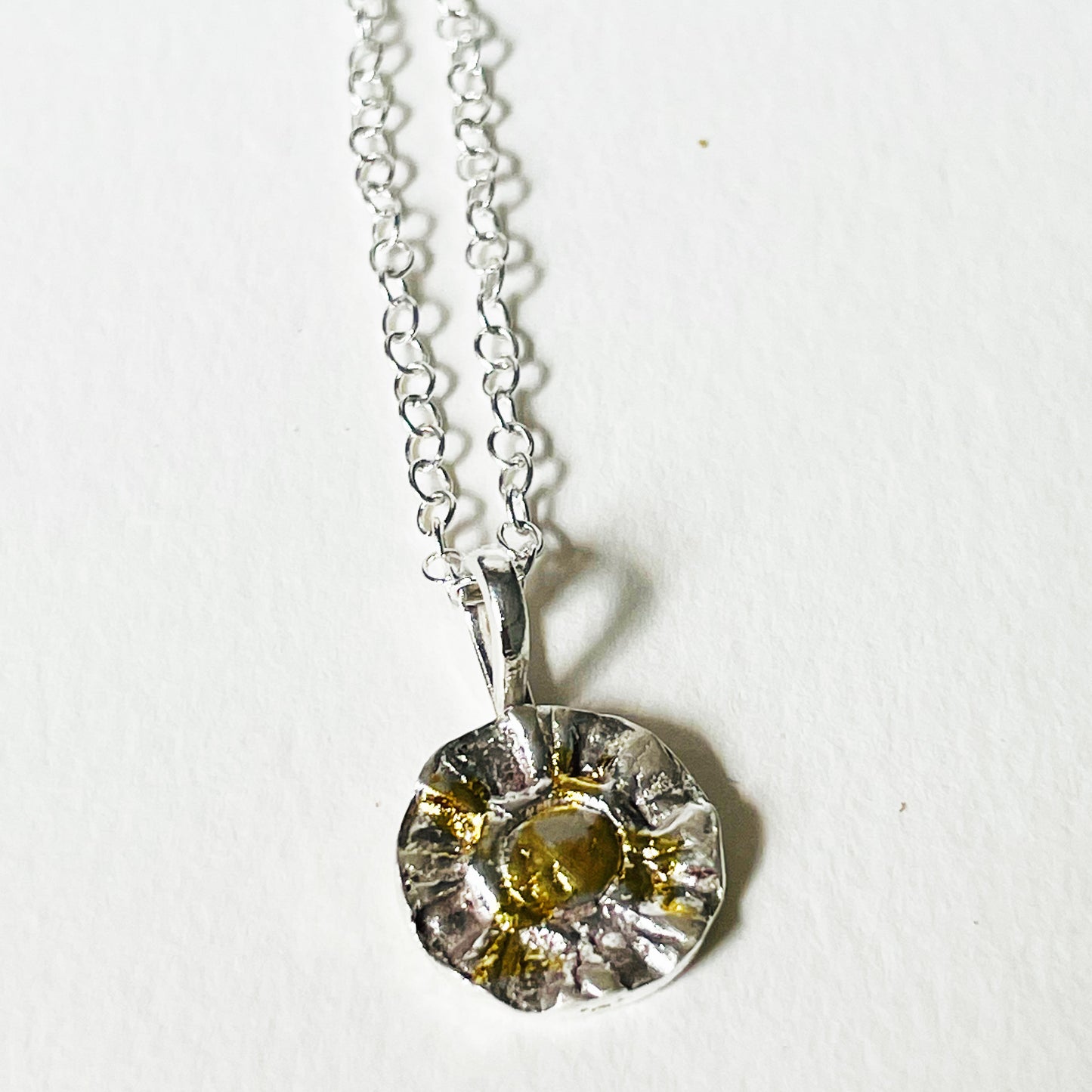 The Radiant Sun Pendant with 22ct gold is joyful! Hand sculpted in recycled solid fine silver (999) with a textured surface and a twinkly beauty all of its own. 22ct heavy gold foil is applied using a traditional Korean gilding technique that makes each piece unique.