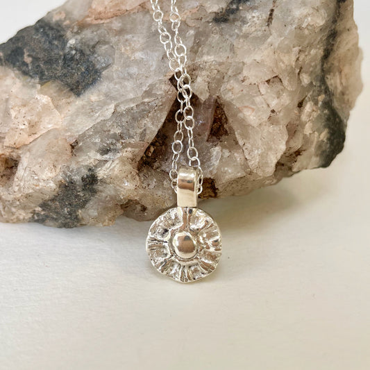 The Radiant Sun Pendant is joyful! Hand sculpted in recycled solid fine silver (999) with a textured surface with a twinkly beauty. It can be worn everyday or as a beautiful detail on more formal occasions.