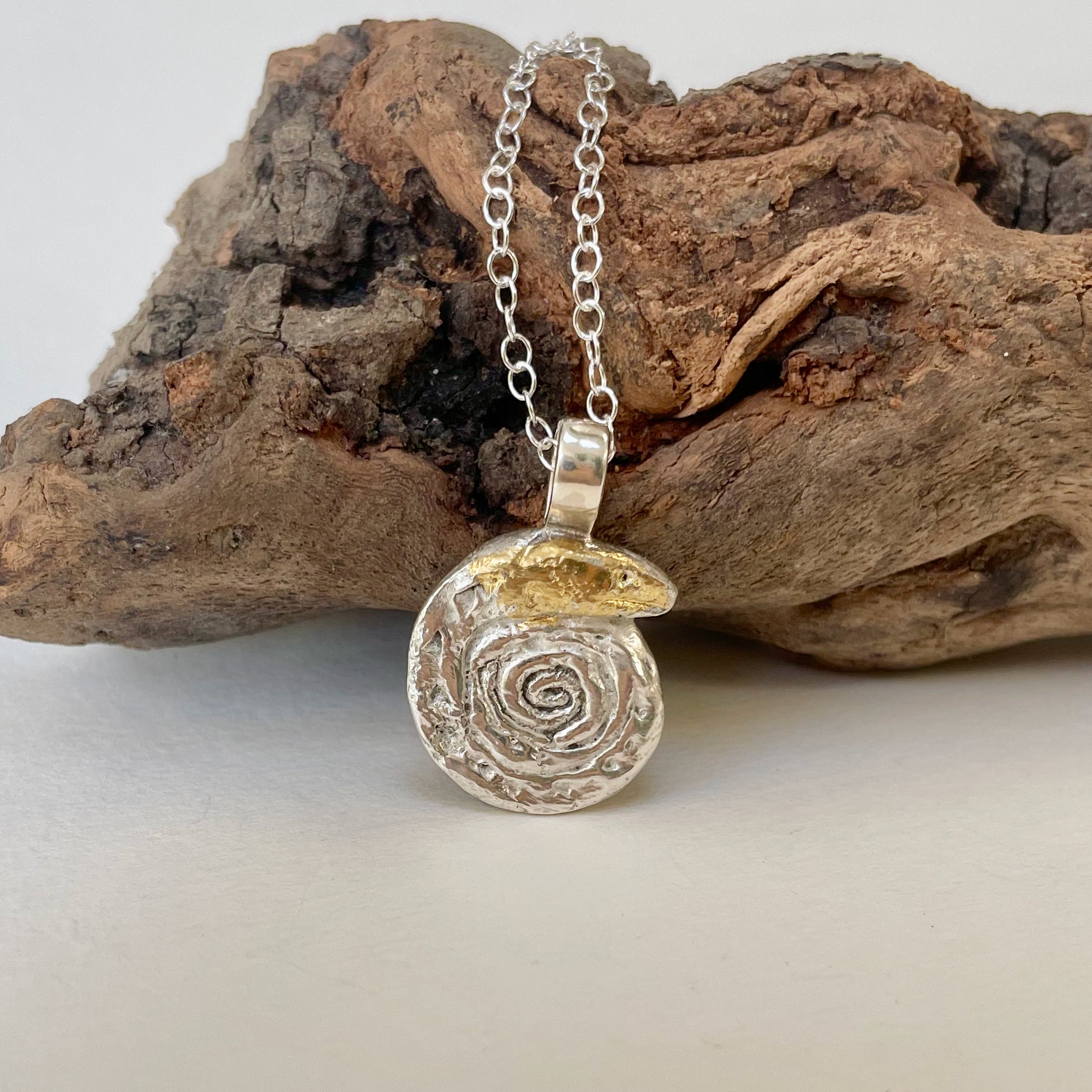 The Expanded Skies Spiral Snake pendant is totally handcrafted in 100% recycled fine silver (999) with 22ct gold.  It has a textured surface that has a twinkly beauty all of its own. 22ct heavy gold foil is applied using keum boo, a traditional Korean gilding technique, that uses heat and pressure, which makes each piece unique. It can be worn every day or for more formal occasions