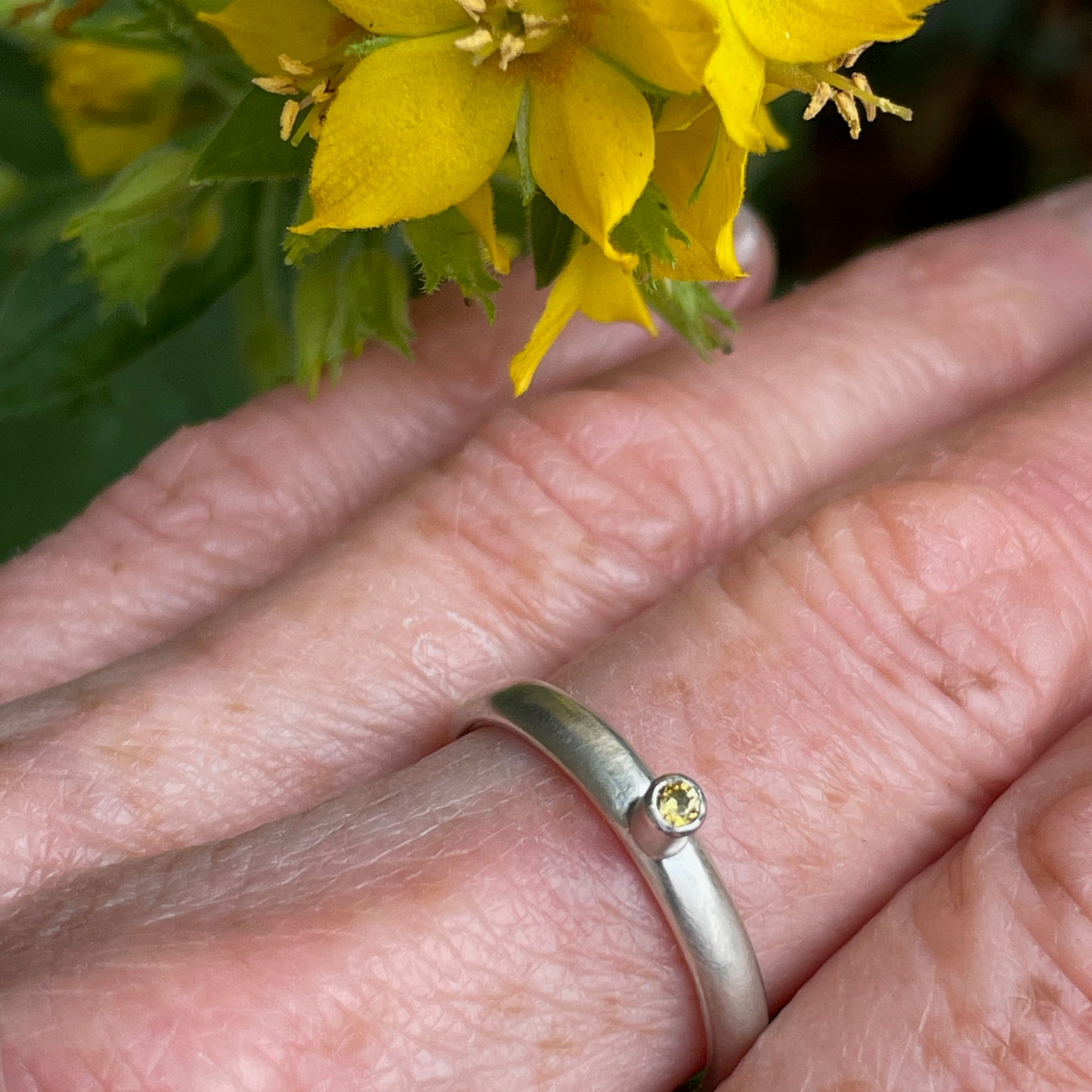 The Sun Beam Yellow Sapphire ring has the clear and simple beauty of golden yellow ethically mined Sri Lankan yellow sapphire set on a matt silver sterling silver band. Understated and beautiful, it can be worn everyday or for special occasions.