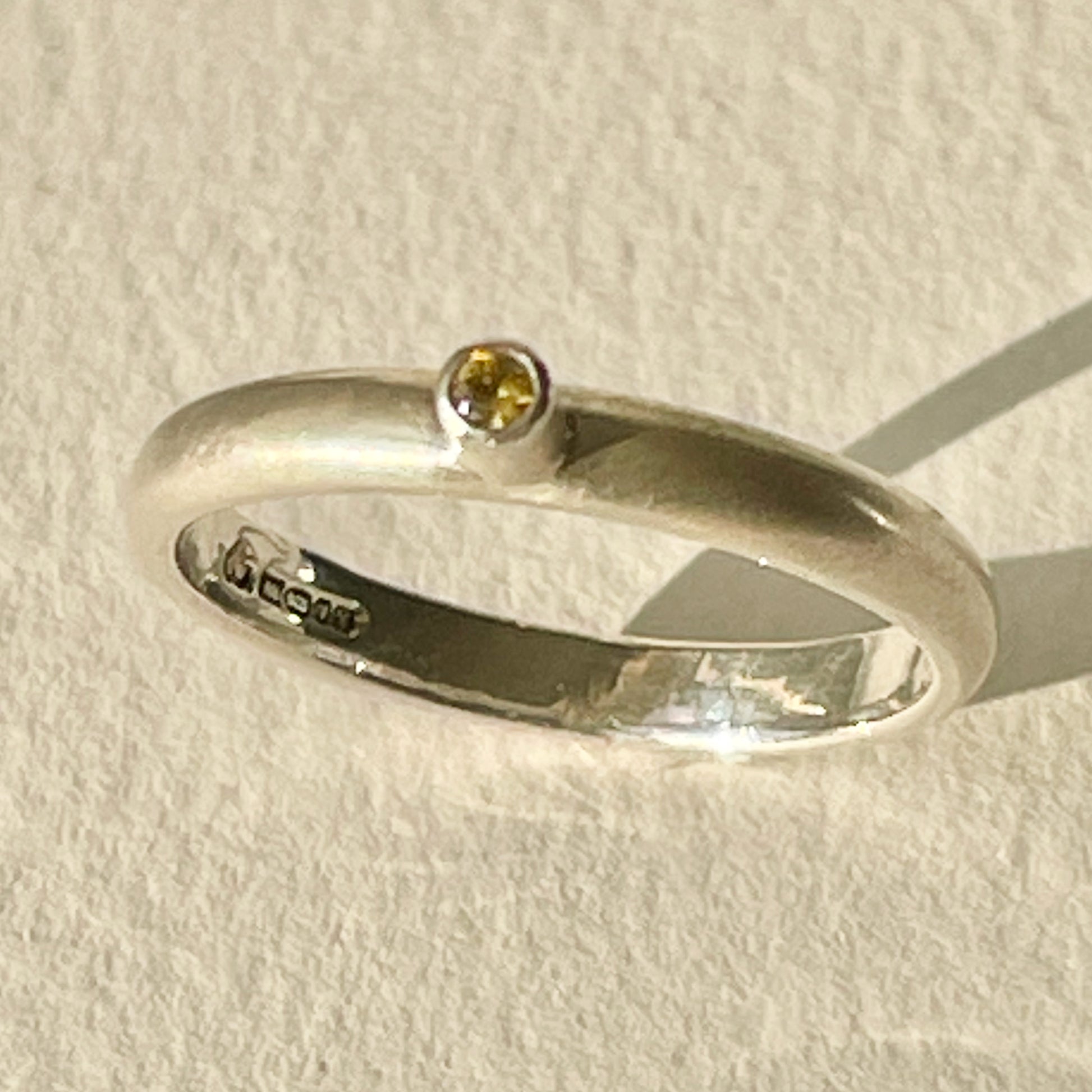 The Sun Beam Yellow Sapphire ring has the clear and simple beauty of golden yellow ethically mined Sri Lankan yellow sapphire set on a matt silver sterling silver band. Understated and beautiful, it can be worn everyday or for special occasions.