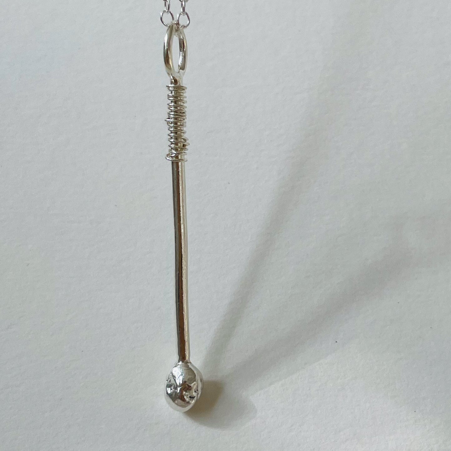 The Ceremonial Drum Stick Pendant has a distinctive design yet is subtle and easy to wear. Handcrafted with a high quality recycled sterling silver (925) shaft and a fine silver (999) drum stick tip.  It is accompanied by a sterling silver chain, available in a range of lengths or a hand strung fine glass seed bead necklace made from beautiful Japanese Miyuki glass seed beads, available in green 